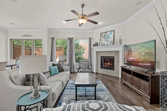 a living room with furniture fireplace and flat screen tv
