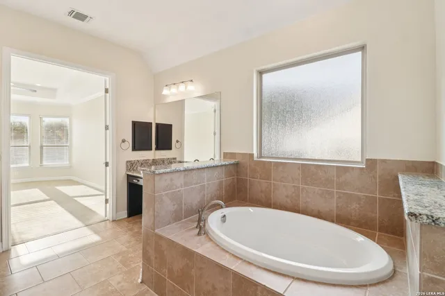 a bathroom with a bathtub and a sink