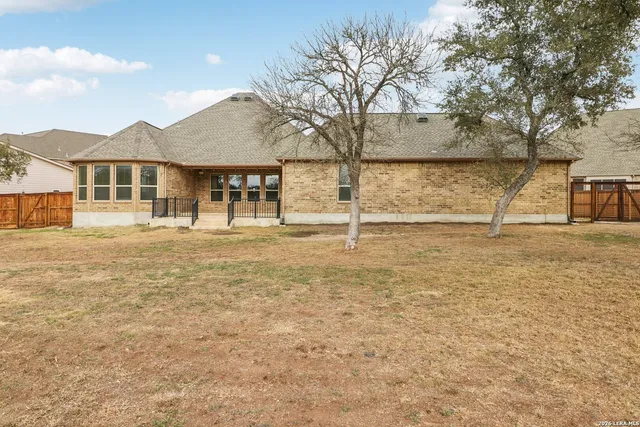 a view of a house with a yard and lake view