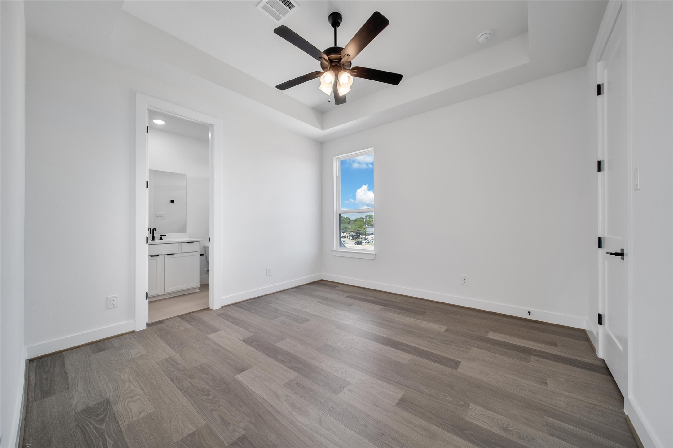 4404 Anthony Court Lane Seabrook, TX 77586 - Photo 17 of 36 an empty room with wooden floor and a ceiling fan