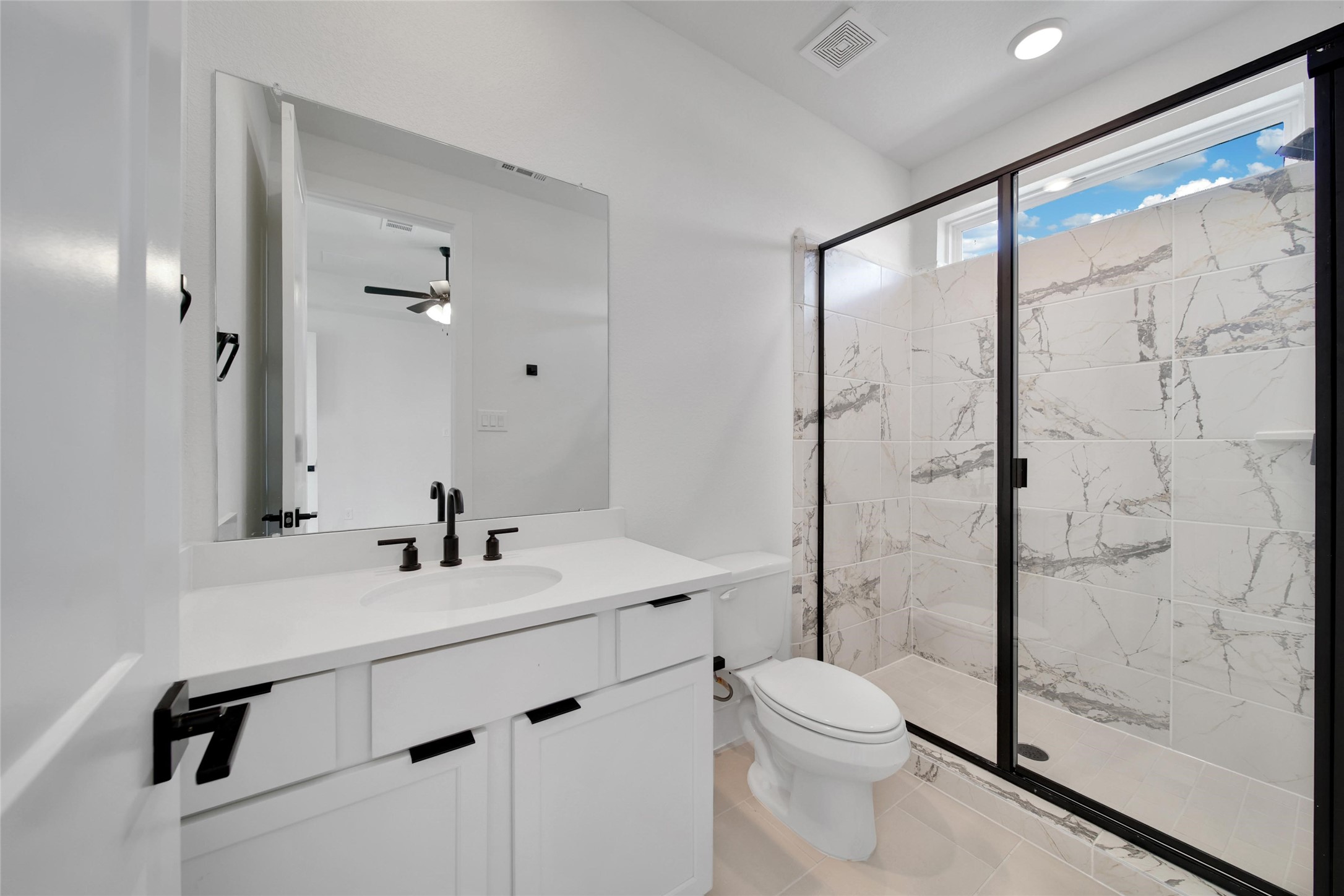 4404 Anthony Court Lane Seabrook, TX 77586 - Photo 20 of 36 a bathroom with a toilet a sink and glass door
