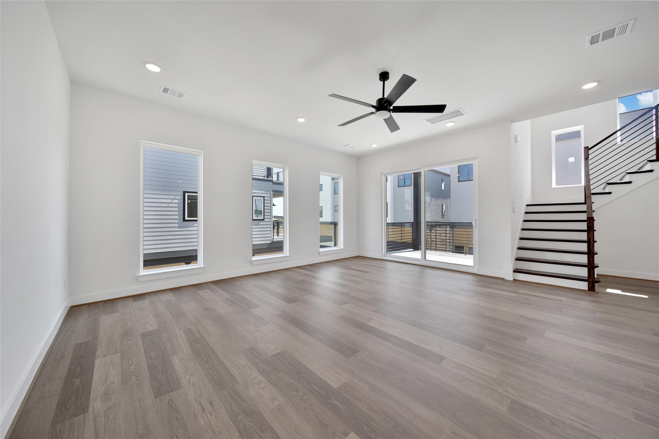4404 Anthony Court Lane Seabrook, TX 77586 - Photo 3 of 36 a view of an empty room with wooden floor and a ceiling fan