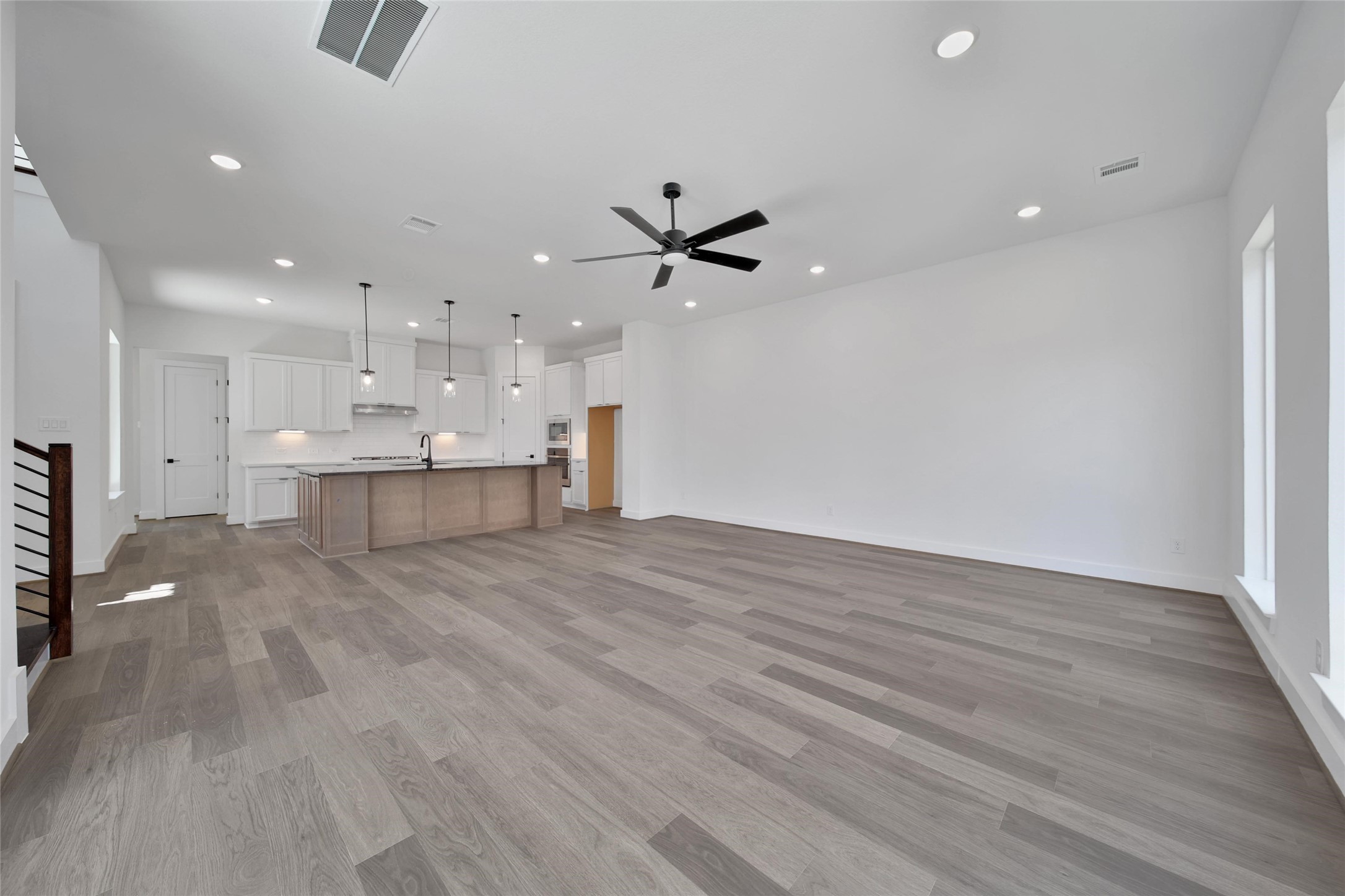 4404 Anthony Court Lane Seabrook, TX 77586 - Photo 6 of 36 a view of an empty room with kitchen appliances and a ceiling fan