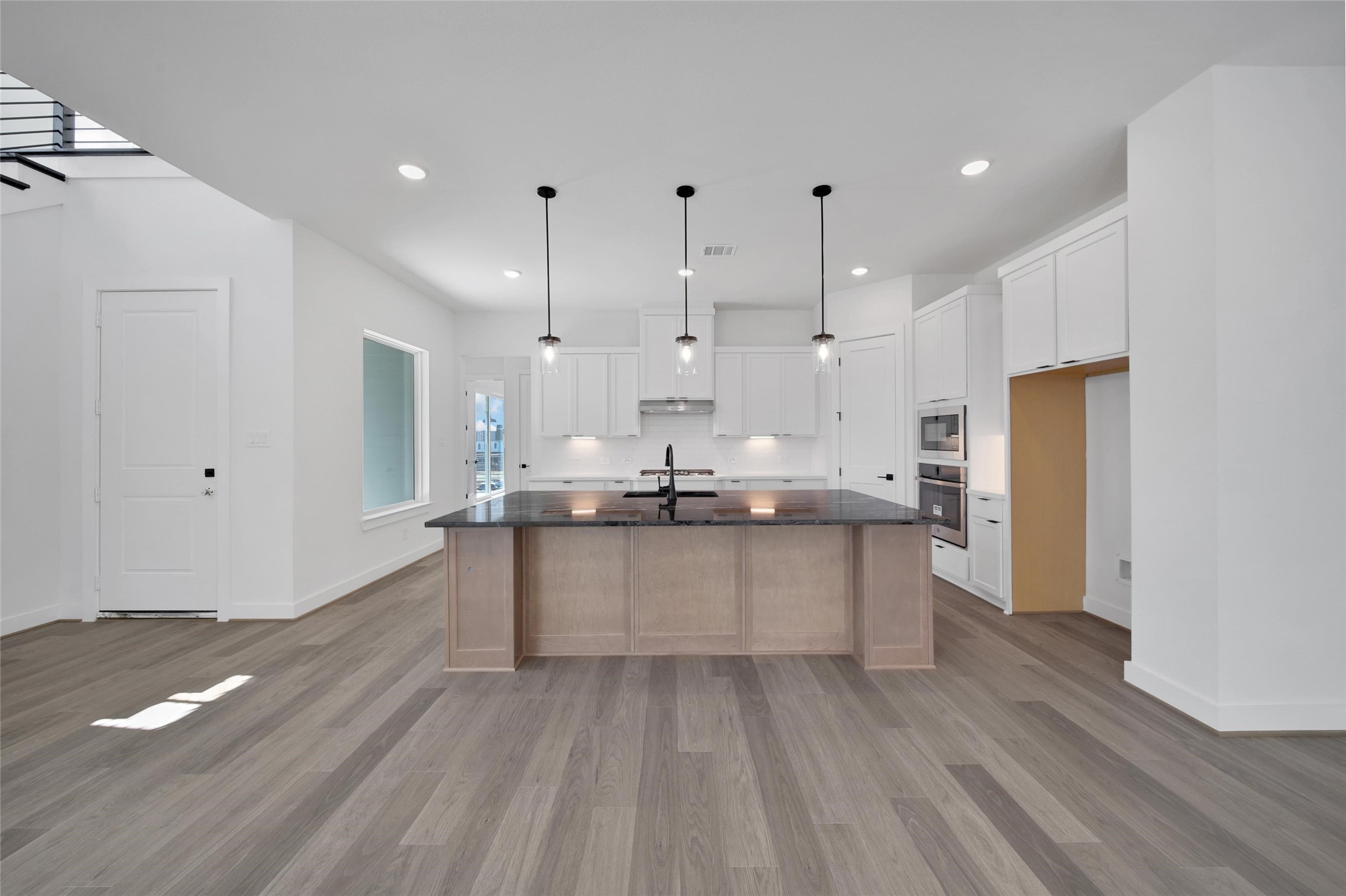 4404 Anthony Court Lane Seabrook, TX 77586 - Photo 7 of 36 a large kitchen with kitchen island a sink stainless steel appliances and cabinets