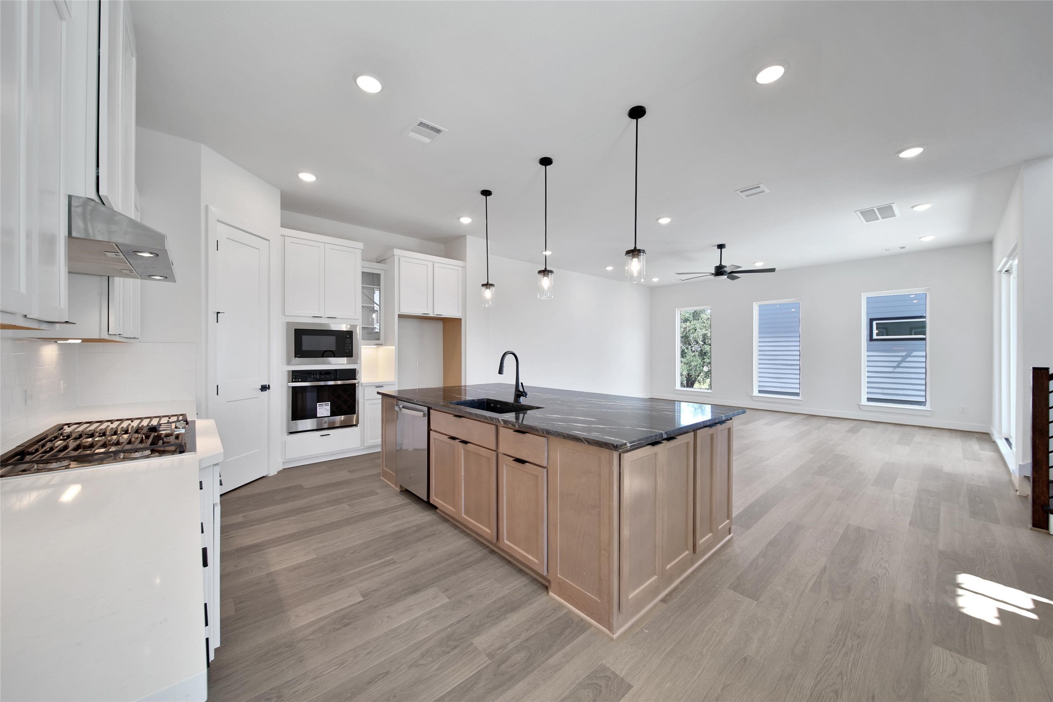 4404 Anthony Court Lane Seabrook, TX 77586 - Photo 9 of 36 a large kitchen with stainless steel appliances granite countertop a stove a sink and a refrigerator