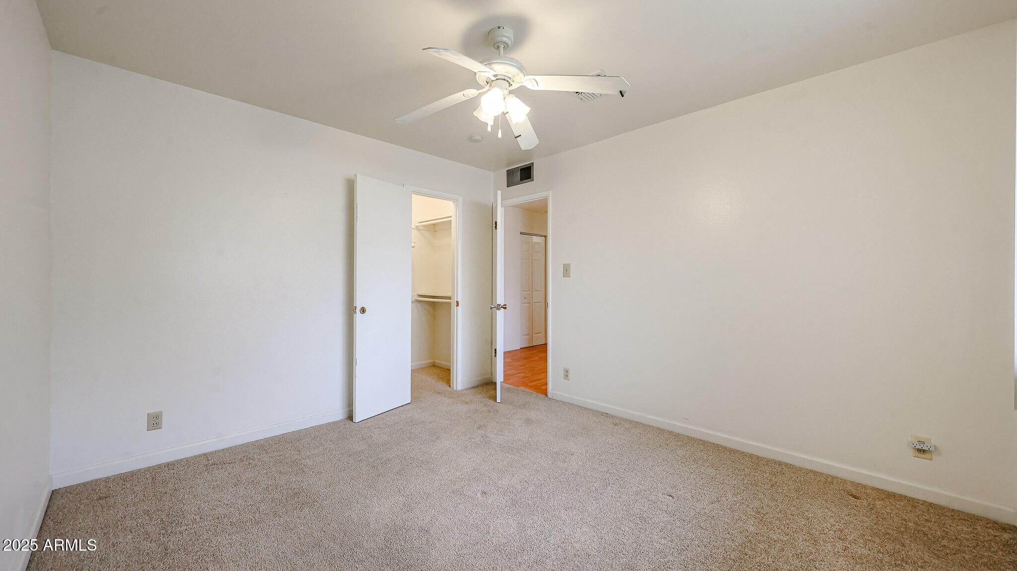 11851 North Thunderbird Road Sun City, AZ 85351 - Photo 24 of 46 an empty room with a ceiling fan and a window