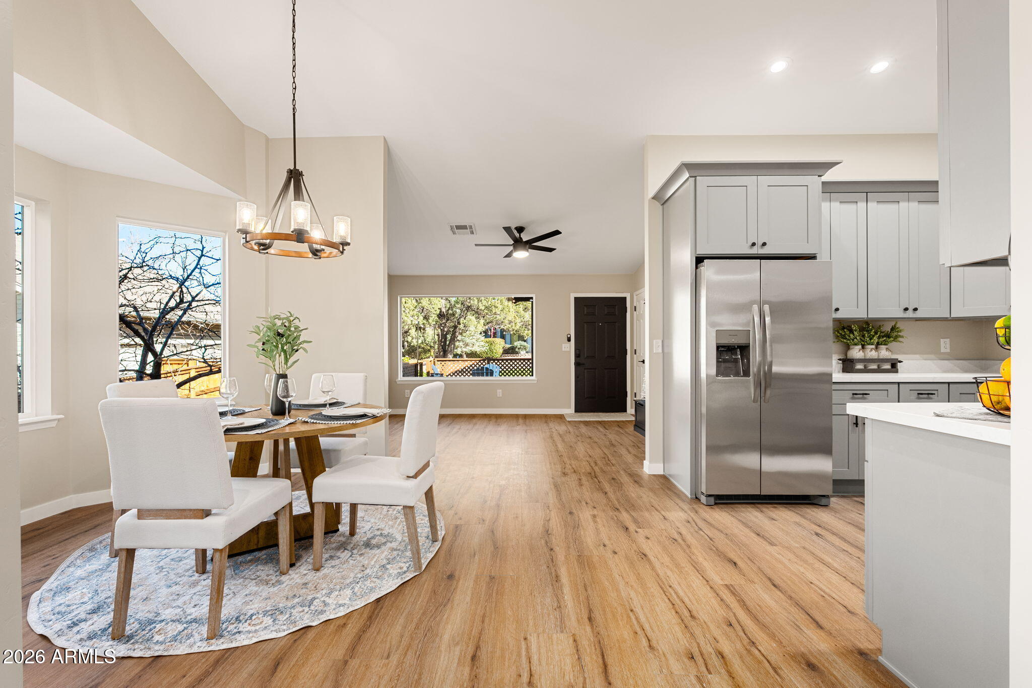 304 North Trailwood Road Payson, AZ 85541 - Photo 7 of 12 a kitchen with stainless steel appliances granite countertop a refrigerator a stove a sink dishwasher a dining table and chairs with wooden floor