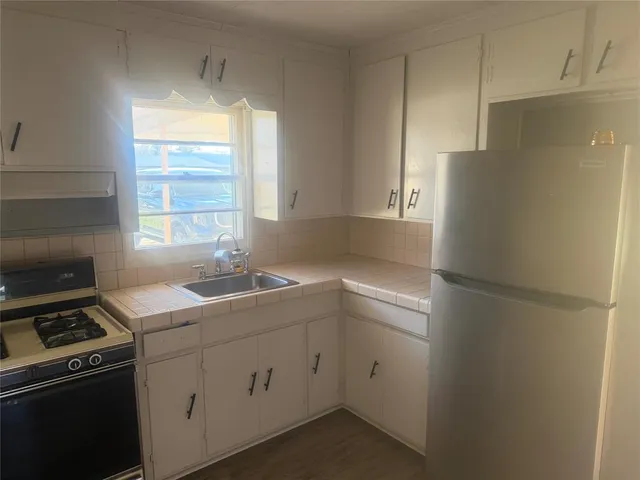 a kitchen with a refrigerator stove and sink
