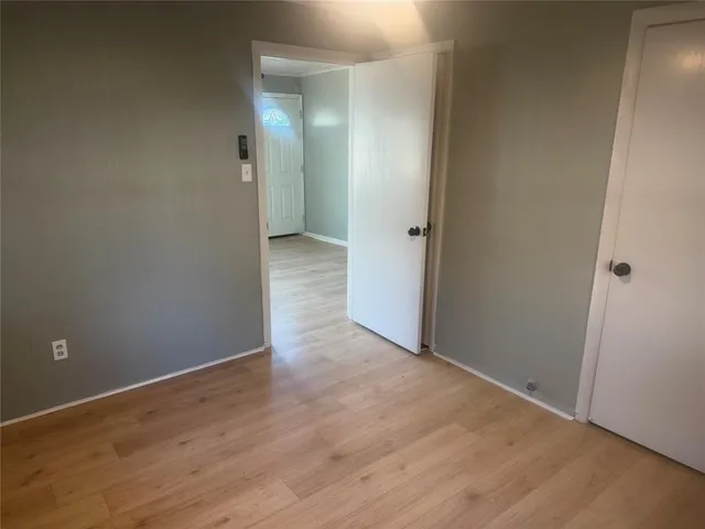 en empty room with windows and fan