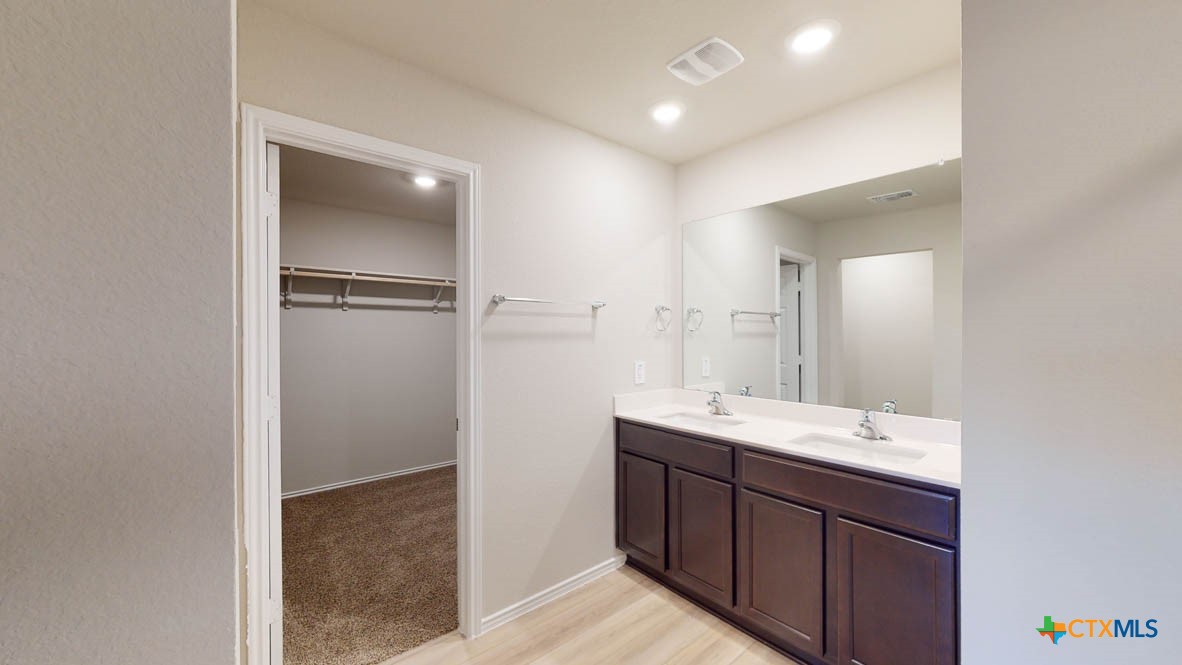 1310 Merritt Road Temple, TX 76504 - Photo 19 of 28 a bathroom with a double vanity sink and mirror
