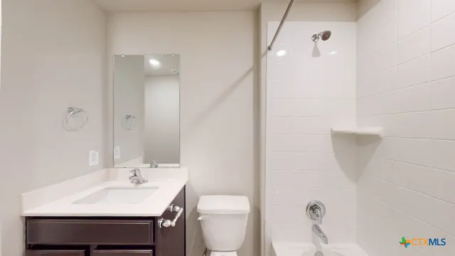 a bathroom with a sink a toilet and vanity