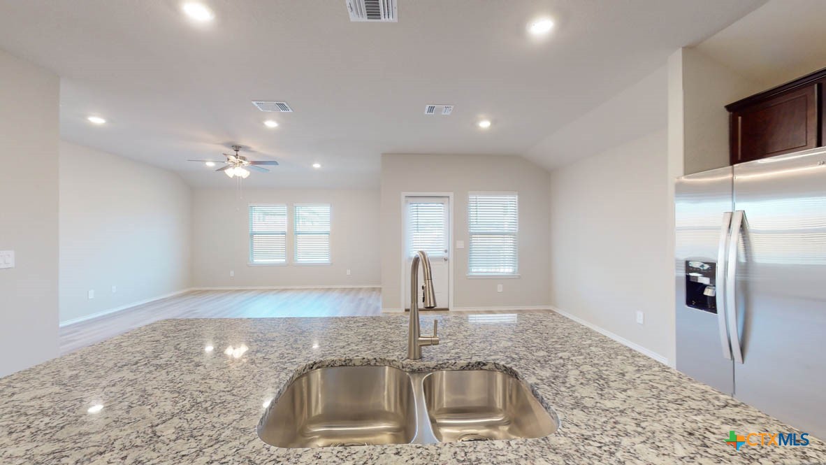 1310 Merritt Road Temple, TX 76504 - Photo 8 of 28 a kitchen with kitchen island a sink stainless steel appliances and a counter top