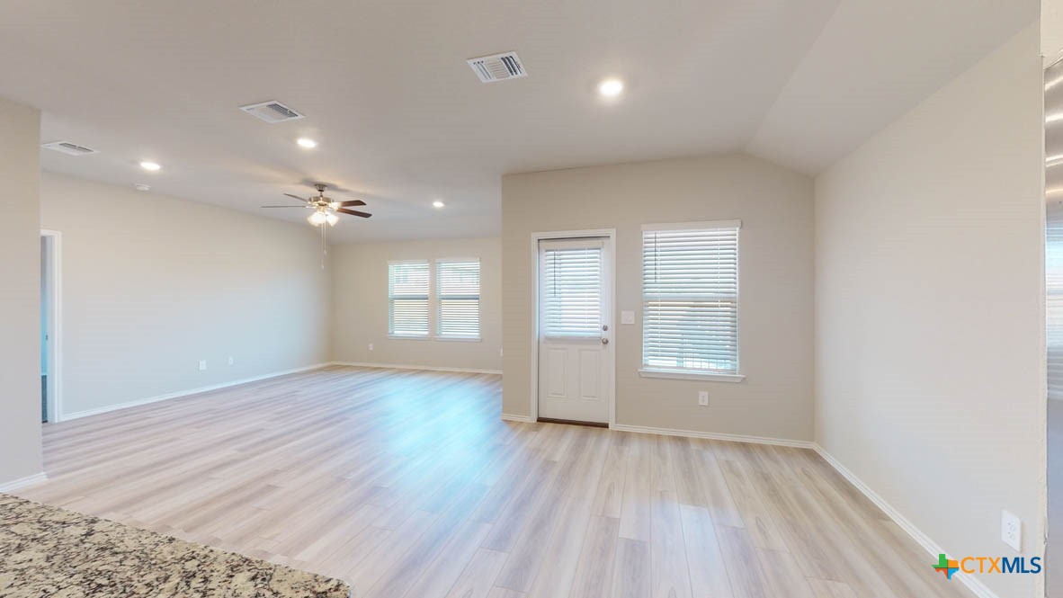 1310 Merritt Road Temple, TX 76504 - Photo 9 of 28 an empty room with wooden floor and windows