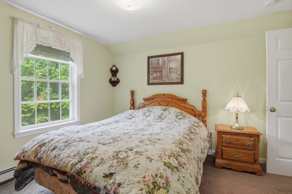 186 Common Street Groton, MA 01450 - Photo 21 of 28 a bedroom with a bed and a window