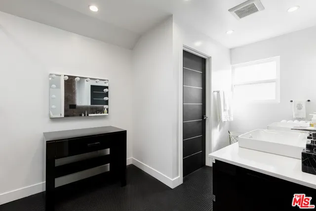 a room with a sink and a mirror