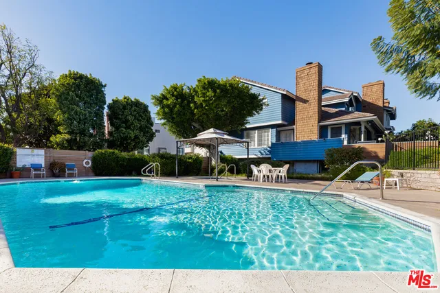 a front view of a house with a yard table and chairs