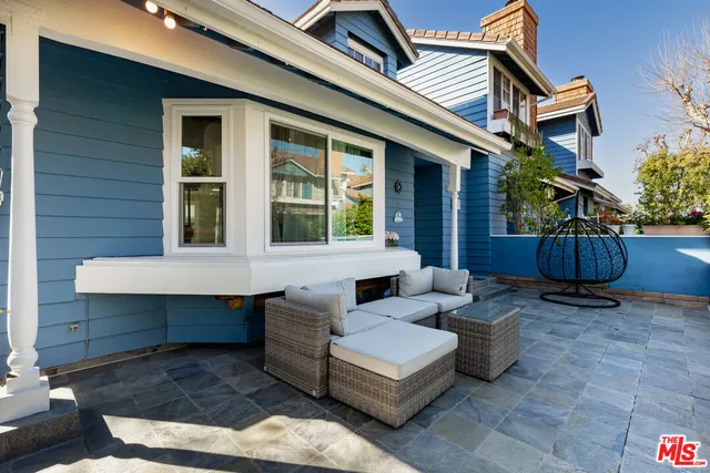 a view of a house with couches chairs and wooden floor