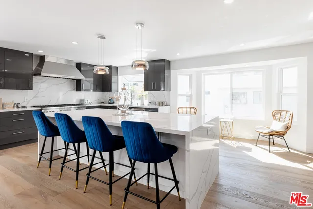a large kitchen with a table and chairs