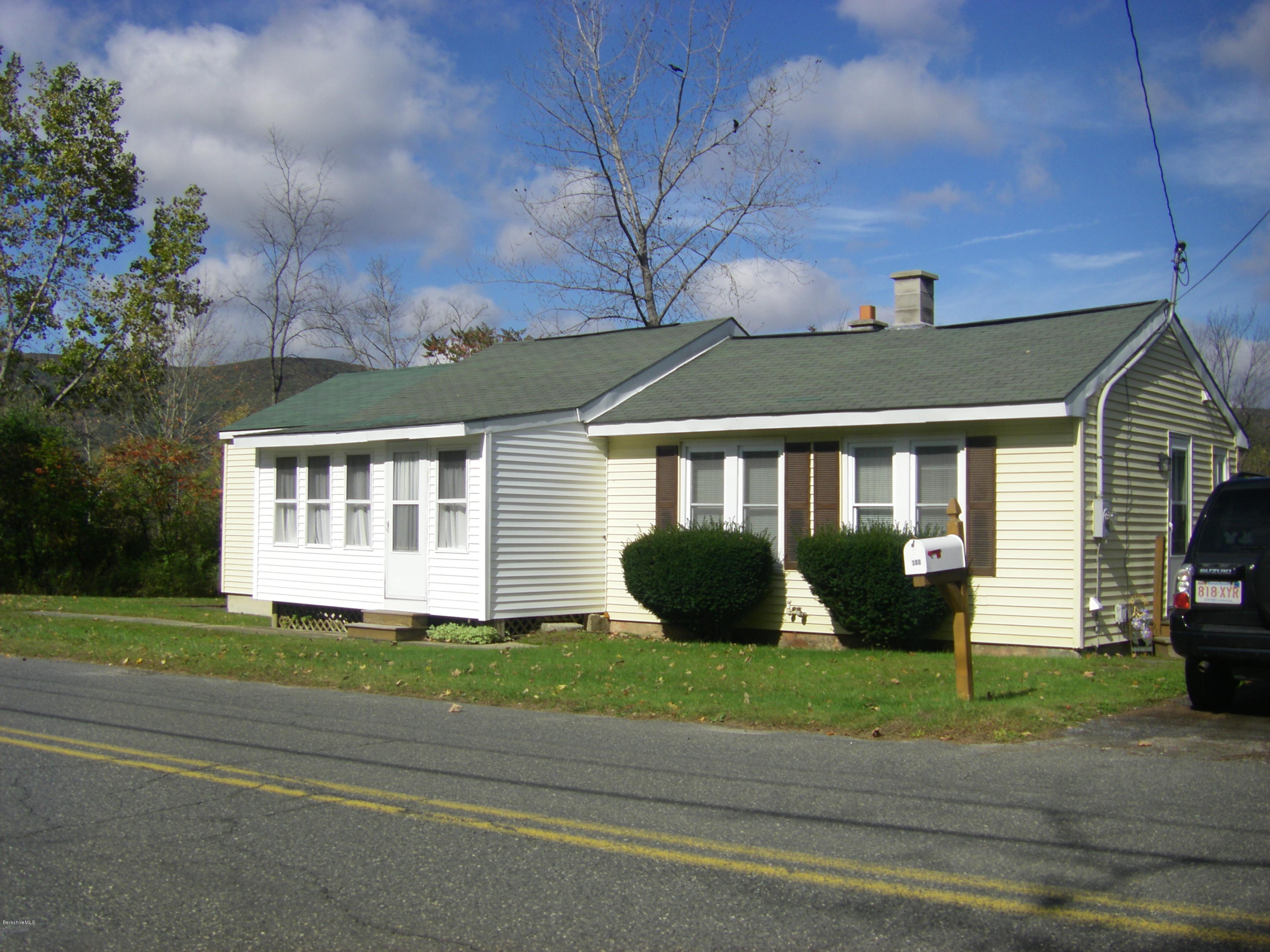 300 Cross Road Clarksburg, MA 01247 - Photo 1 of 29 a front view of a house with a garden and trees