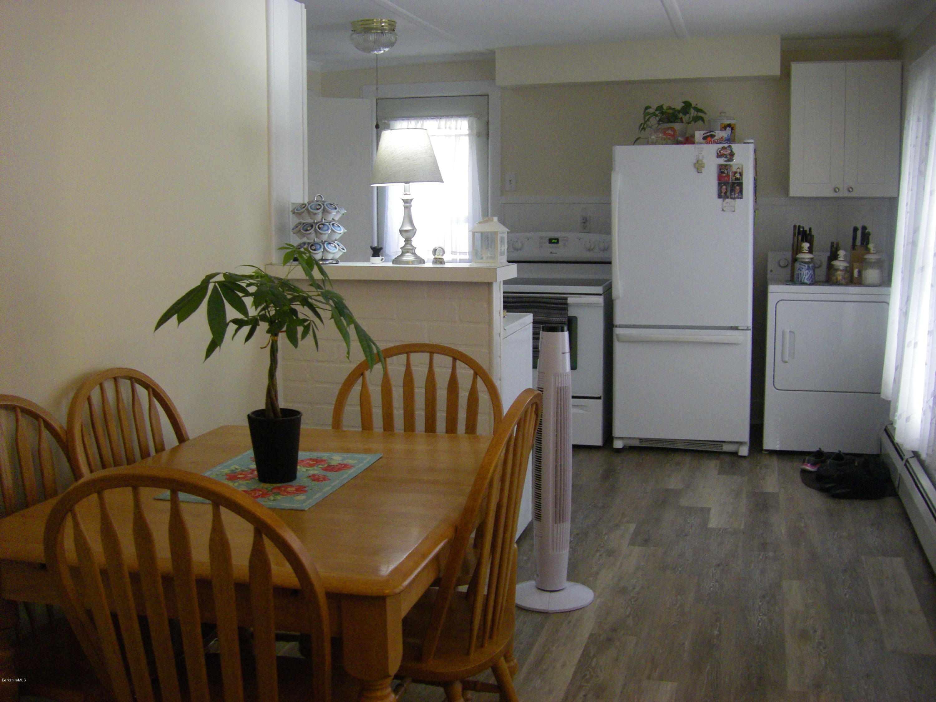 300 Cross Road Clarksburg, MA 01247 - Photo 14 of 29 a kitchen with a refrigerator and a table