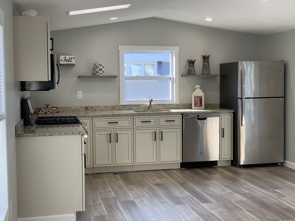 a kitchen with a refrigerator sink and stove