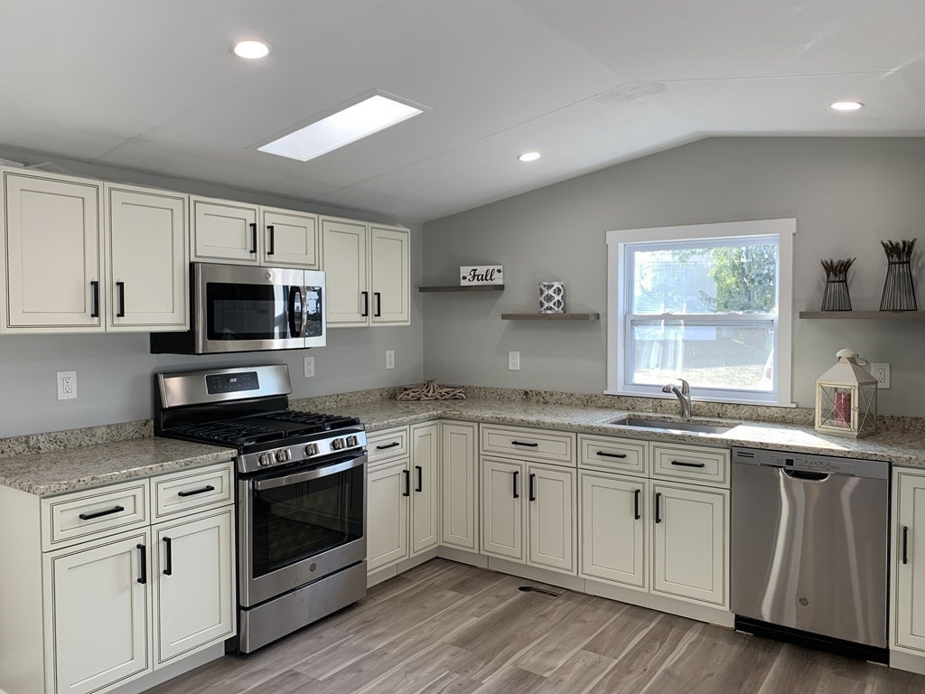 194 Lafayette Road Salisbury, MA 01952 - Photo 3 of 9 a kitchen with granite countertop white cabinets and stainless steel appliances