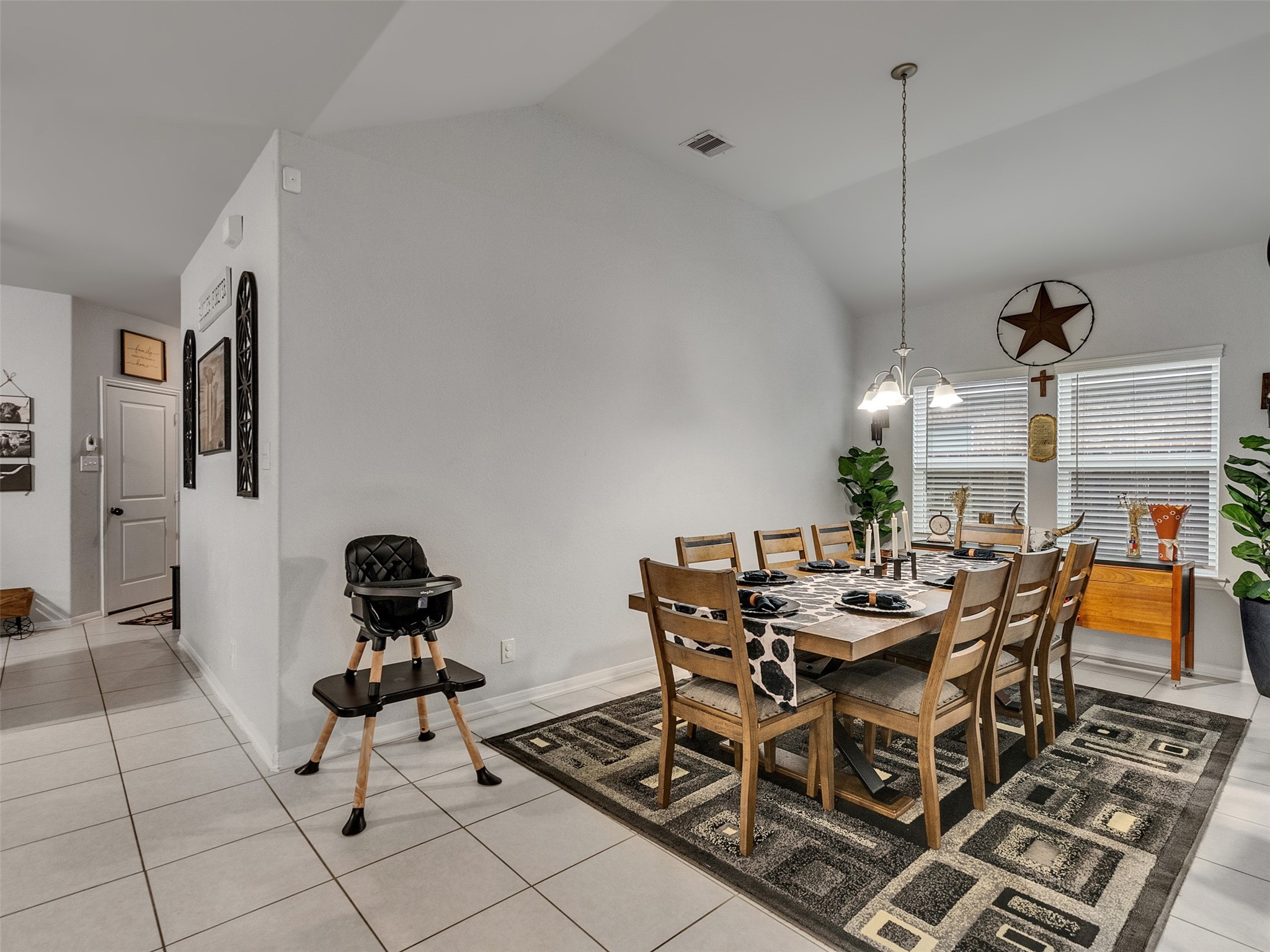 8719 Willet Street Baytown, TX 77521 - Photo 19 of 42 a view of a dining room with furniture and chandelier