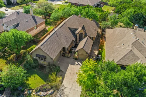 an aerial view of a house with a yard