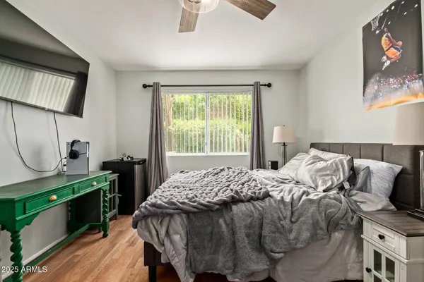 a bedroom with a bed and a chandelier