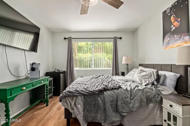 a bedroom with a bed and a chandelier