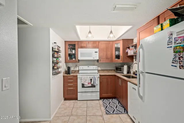 a kitchen with stainless steel appliances granite countertop a refrigerator and a sink
