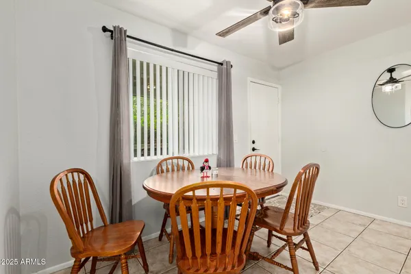 a kitchen with stainless steel appliances a table chairs and a refrigerator