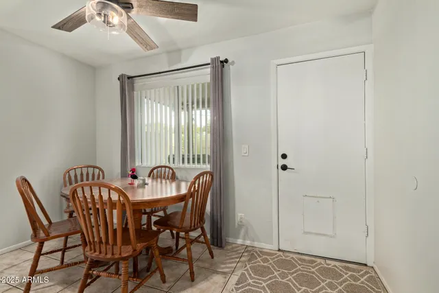 a view of a dining room with furniture and a window