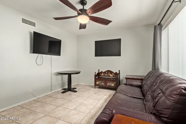a large bed sitting in a bedroom next to a window
