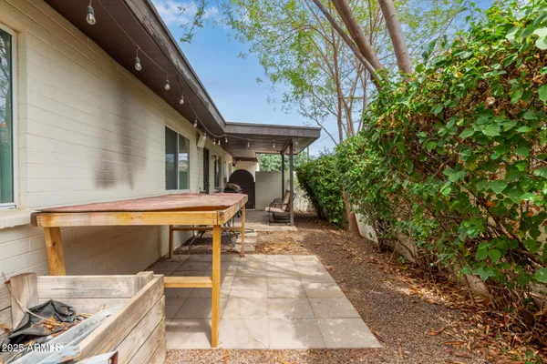 a backyard of a house with lots of green space and fountain