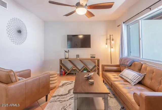 a kitchen with stainless steel appliances granite countertop a refrigerator a sink dishwasher a dining table and chairs with wooden floor