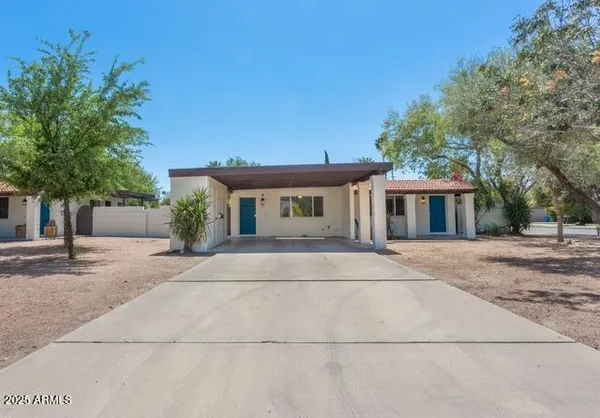 a bedroom with a bed and a lamp