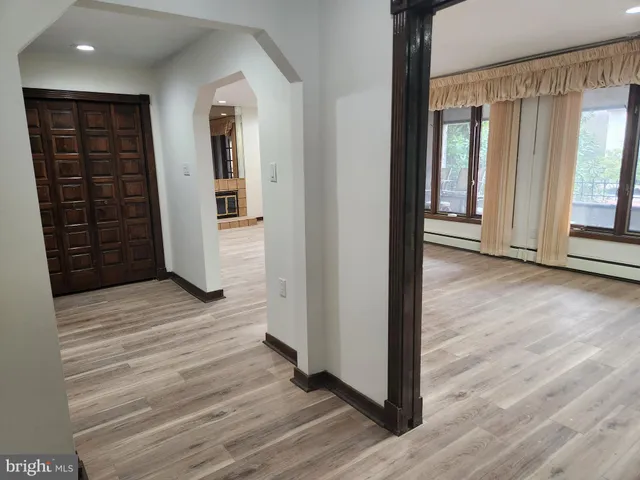 a view of a room with wooden floor and windows