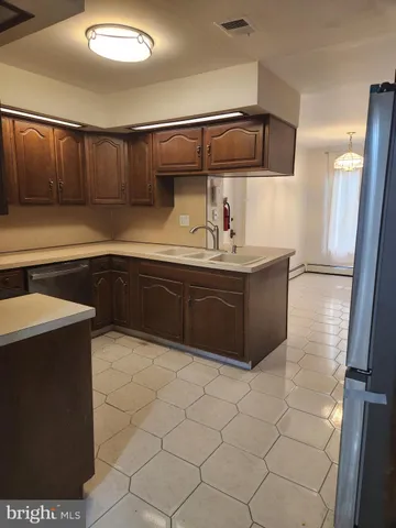 a kitchen with stainless steel appliances granite countertop a sink and cabinets