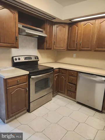 a kitchen with a stove top oven sink and cabinets