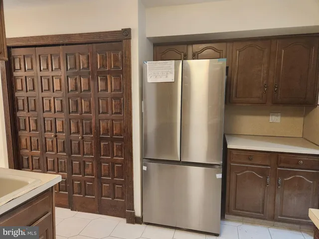 a kitchen with metallic refrigerator freezer and a dishwasher