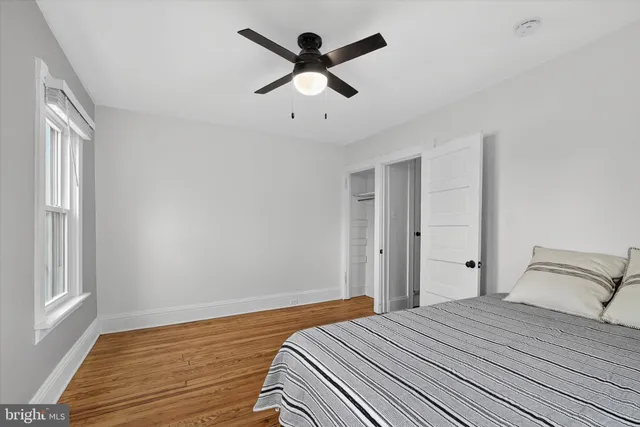 a bedroom with bed and wooden floor