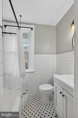 a bathroom with a shower toilet and sink