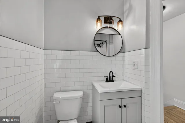 a bathroom with a toilet a sink and a mirror