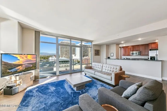 a living room with furniture wooden floor and a flat screen tv
