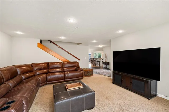 a kitchen with stainless steel appliances granite countertop a refrigerator a stove a sink dishwasher and a refrigerator with wooden floor