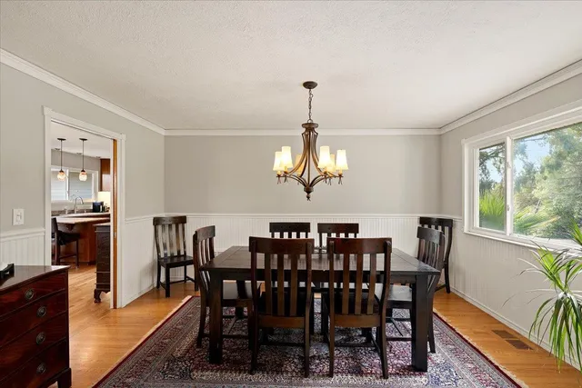 a dining room with furniture and wooden floor