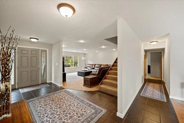 a spacious bedroom with a bed and wooden floor