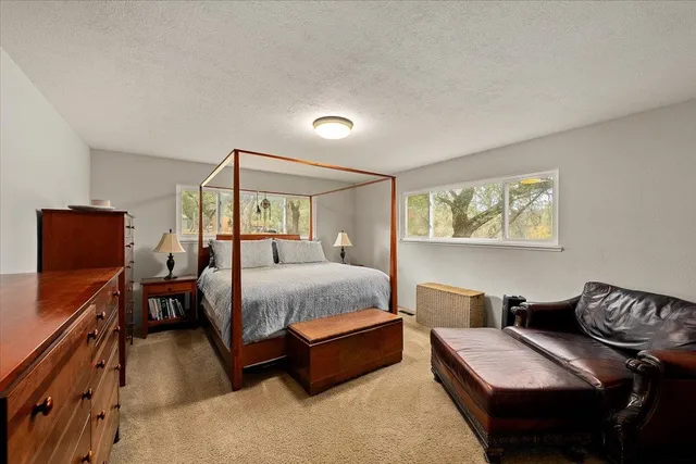 a view of a roof deck with table and chairs under an umbrella with wooden floor