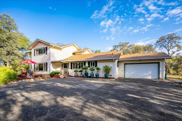 a view of a house with garden and sitting area